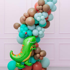 A colorful balloon garland featuring a dinosaur-themed balloon prominently placed amidst a variety of other shapes and colors.