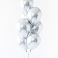 A bunch of silver-colored balloons tied together against a white background.