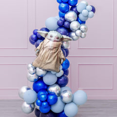 A balloon garland featuring a Star Wars theme with various shaped balloons in blue, silver, and gold colors, assembled to form a decorative arch.