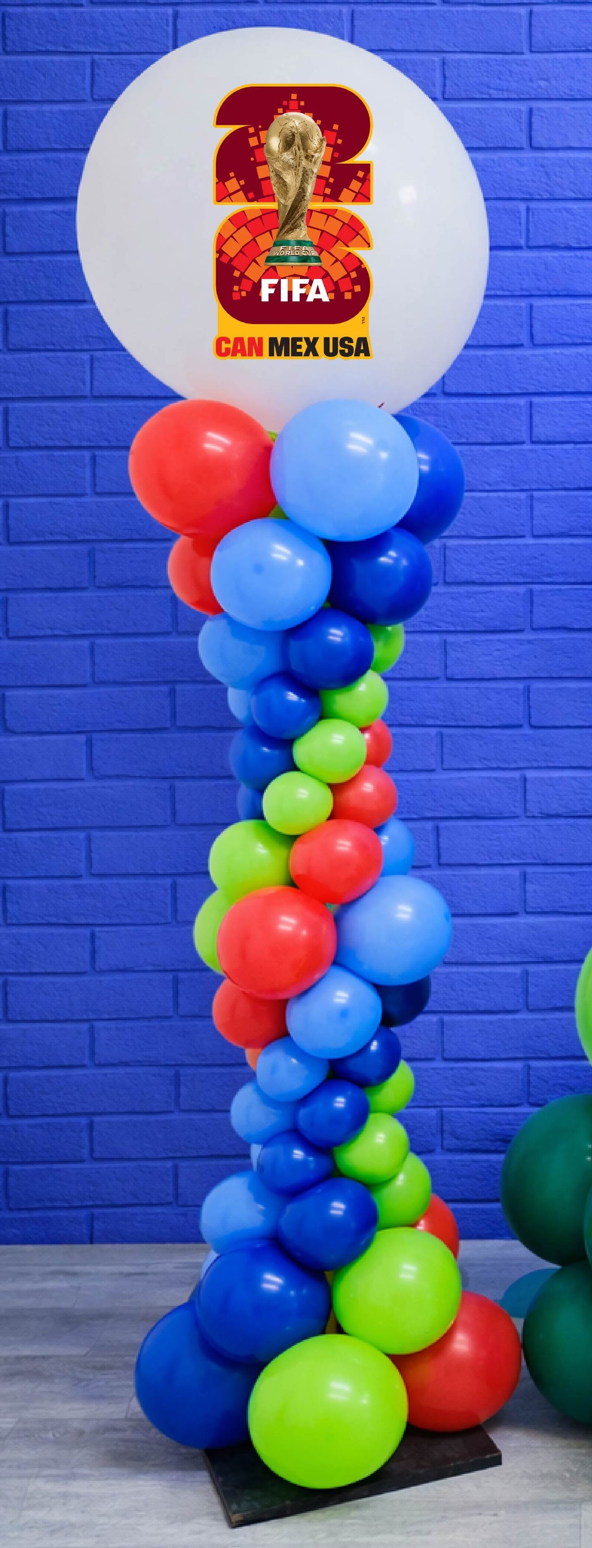 Balloon column with FIFA World Cup 2023 logo against a blue brick wall.