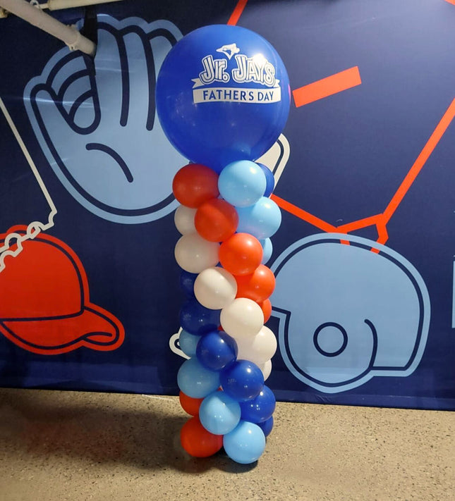 Balloon column with 'Jr. Jays' Fathers Day' theme in front of a blue background with sports graphics.