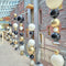 Decorative arrangement of black, white, and gold balloons hanging from a ceiling.