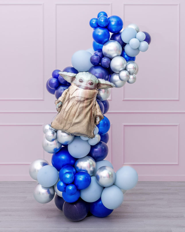 A balloon garland featuring a Star Wars theme with various shaped balloons in blue, silver, and gold colors, assembled to form a decorative arch.