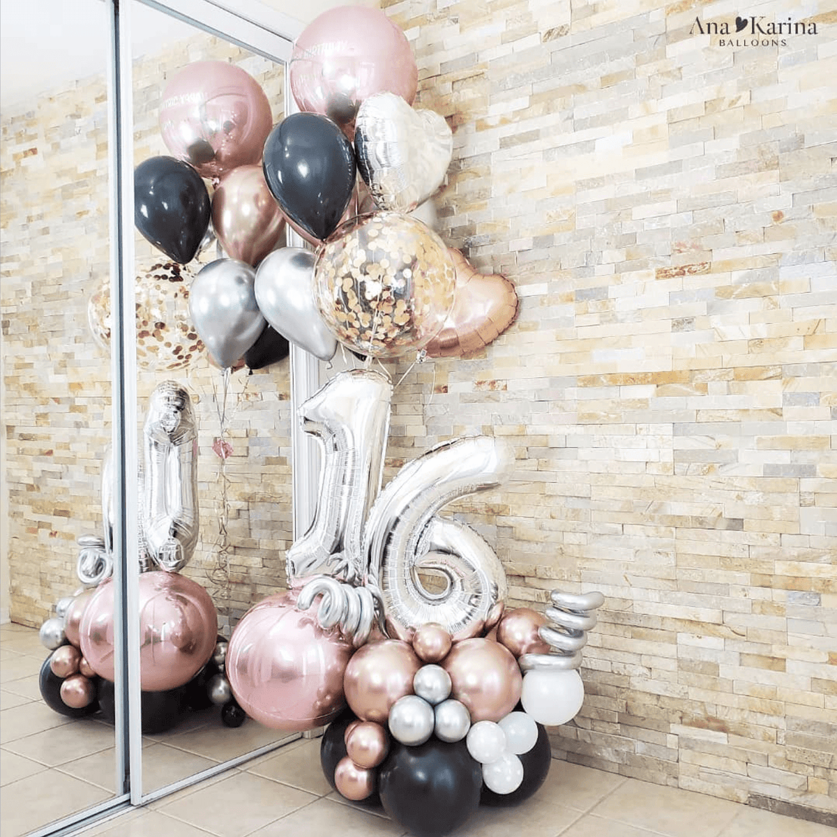 A bouquet of rose gold and black balloons arranged to form the number 16, with additional balloons in various shapes and colors.